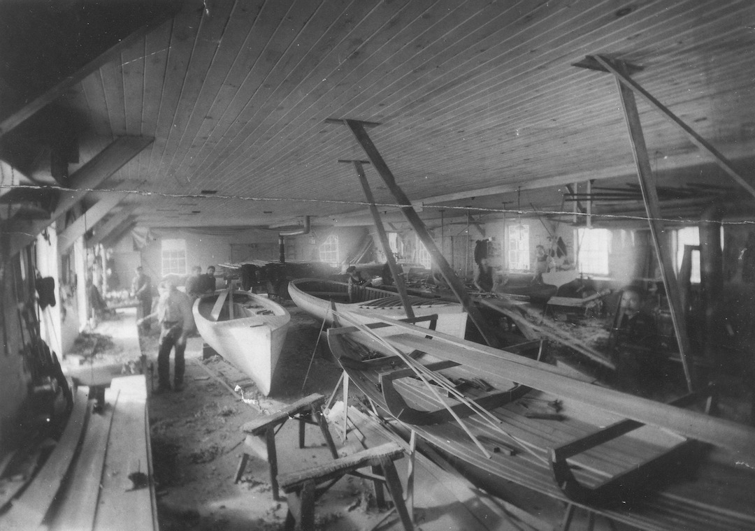 Black and white photograph showing several launches under construction at the J.W. Stone Boat Manufacturing workshop.