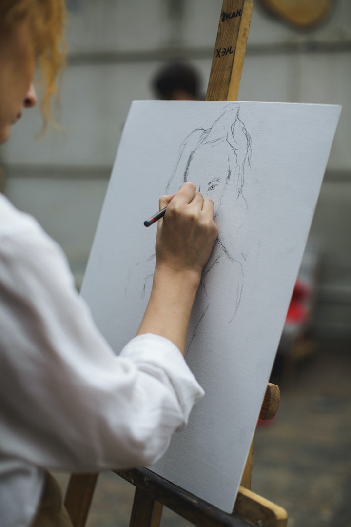 woman drawing at an easel