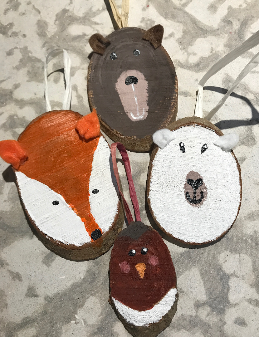Four Christmas ornaments of forest creatures