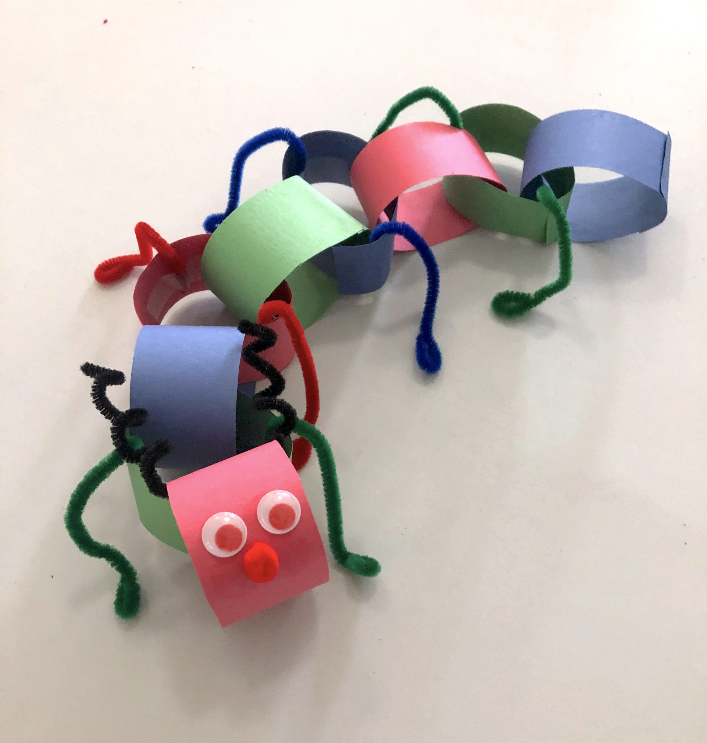 Photo depicting a colourful paper chain catepillar craft.
